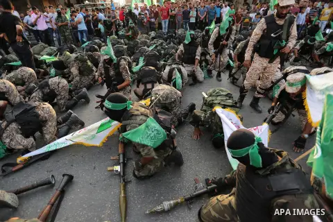 Palestinian Hamas militants take part in a military show against Israel's newly-installed security measures at the entrance to the al-Aqsa mosque compound, in Khan Younis, in the southern Gaza Strip July 20, 2017. Photo...