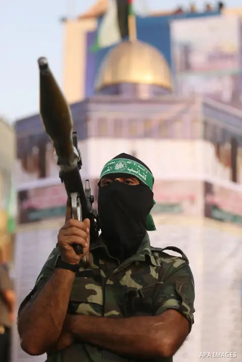 Palestinian Hamas militants take part in a military show against Israel's newly-installed security measures at the entrance to the al-Aqsa mosque compound, in Khan Younis, in the southern Gaza Strip July 20, 2017. Photo...