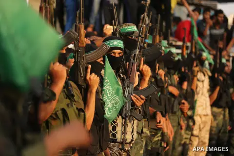 Palestinian Hamas militants take part in a military show against Israel's newly-installed security measures at the entrance to the al-Aqsa mosque compound, in Khan Younis, in the southern Gaza Strip July 20, 2017. Photo...