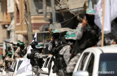 Palestinian Hamas militants take part in a protest against Israel's new security measures at the entrance to the al-Aqsa mosque compound, which include metal detectors and cameras, in Khan Younis in the the southern Gaza...
