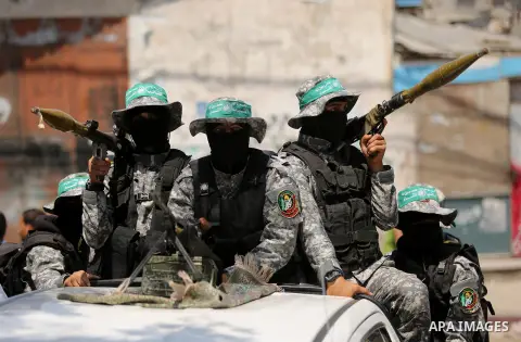 Palestinian Hamas militants take part in a protest against Israel's new security measures at the entrance to the al-Aqsa mosque compound, which include metal detectors and cameras, in Khan Younis in the the southern Gaza...