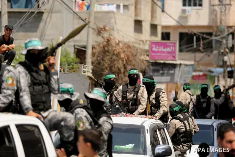 Palestinian Hamas militants take part in a protest against Israel's new security measures at the entrance to the al-Aqsa mosque compound, which include metal detectors and cameras, in Khan Younis in the the southern Gaza...