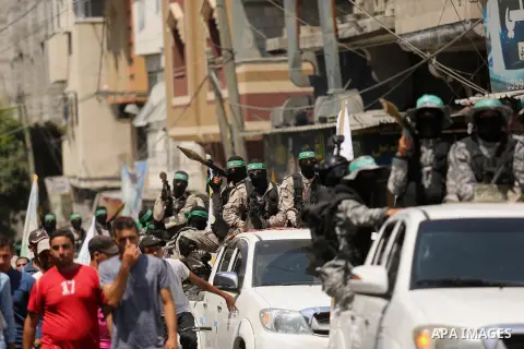 Palestinian Hamas militants take part in a protest against Israel's new security measures at the entrance to the al-Aqsa mosque compound, which include metal detectors and cameras, in Khan Younis in the the southern Gaza...