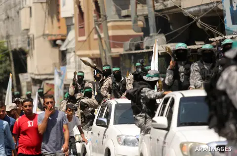 Palestinian Hamas militants take part in a protest against Israel's new security measures at the entrance to the al-Aqsa mosque compound, which include metal detectors and cameras, in Khan Younis in the the southern Gaza...