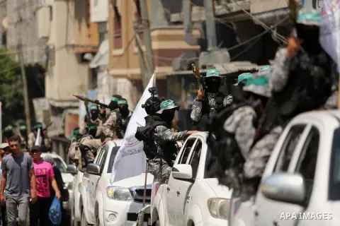 Palestinian Hamas militants take part in a protest against Israel's new security measures at the entrance to the al-Aqsa mosque compound, which include metal detectors and cameras, in Khan Younis in the the southern Gaza...
