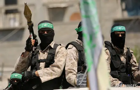 Palestinian Hamas militants take part in a protest against Israel's new security measures at the entrance to the al-Aqsa mosque compound, which include metal detectors and cameras, in Khan Younis in the the southern Gaza...