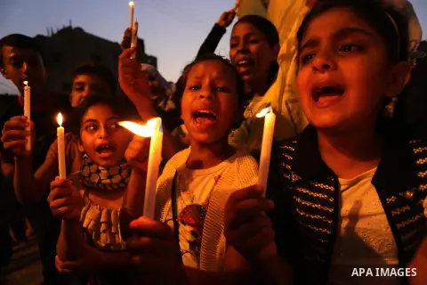 Palestinian children hold candles during a protest against Israel's newly-installed security measures at the entrance to the al-Aqsa mosque compound, in Khan Younis in the southern Gaza Strip July 23, 2017. Photo by Ashr...