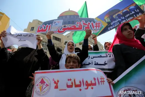 Palestinian protesters shout slogans and hold placards during a demonstration against Israeli security measures that were implemented at the Al-Aqsa mosque compound in Jerusalem the previous week prior to being removed a...