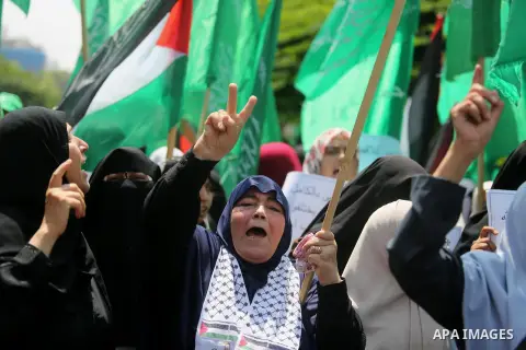 Palestinian protesters shout slogans and hold placards during a demonstration against Israeli security measures that were implemented at the Al-Aqsa mosque compound in Jerusalem the previous week prior to being removed a...