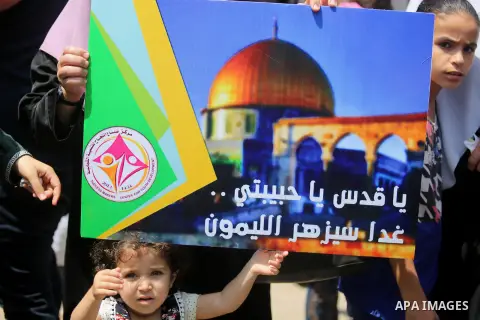 Palestinian protesters shout slogans and hold placards during a demonstration against Israeli security measures that were implemented at the Al-Aqsa mosque compound in Jerusalem the previous week prior to being removed a...