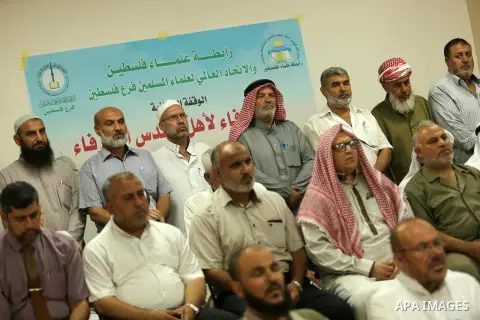 Members of Palestine Scholars Association attend a press conference to show solidarity with Palestinians in Jerusalem, in Gaza city on July 30, 2017. Photo by Ashraf Amra