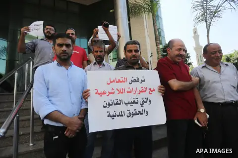 Palestinians, employed by the Palestinian Authority take part in a protest demanding their salaries in Gaza city on August 1, 2017. Photo by Mohammed Asad