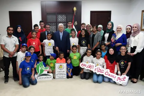 Palestinian President Mahmoud Abbas meets with children of the Basma Ata'a camp, at his headquarter in the West Bank city of Ramallah, on August 2, 2017. Photo by Thaer Ganaim