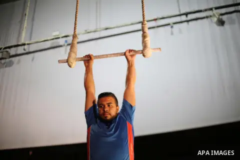 One of the Irish trainer Jennifer Higgins's students from Gaza circus to performs during an aerial silks practice class in Gaza City, on August 3, 2017. Photo by Mohammed Asad
