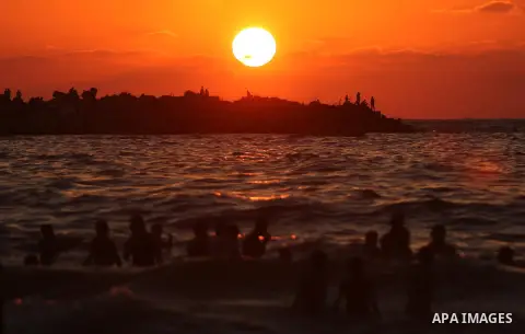 Palestinians enjoy their time at the beach of the Mediterranean sea on the coast of Gaza city on August 4, 2017. Photo by Ashraf Amra