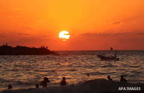 Palestinians enjoy their time at the beach of the Mediterranean sea on the coast of Gaza city on August 4, 2017. Photo by Ashraf Amra