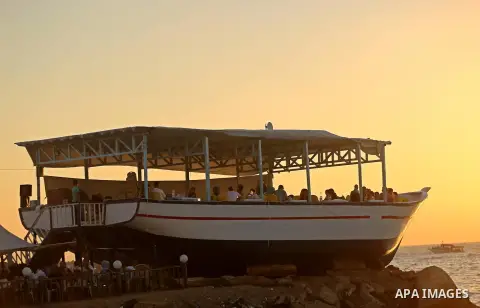 Palestinians are seen aboard "Lolo Rose" ship which has become a popular restaurant, on a beach in Gaza City on August 4, 2017. Photo by Ashraf Amra