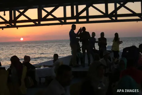 Palestinians are seen aboard "Lolo Rose" ship which has become a popular restaurant, on a beach in Gaza City on August 4, 2017. Photo by Ashraf Amra