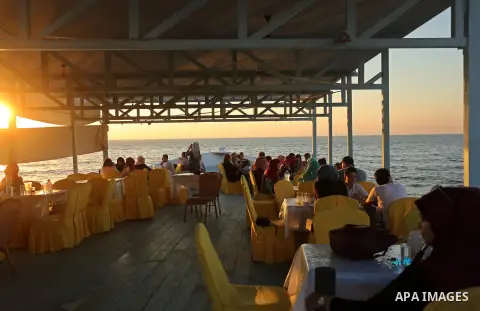 Palestinians are seen aboard "Lolo Rose" ship which has become a popular restaurant, on a beach in Gaza City on August 4, 2017. Photo by Ashraf Amra