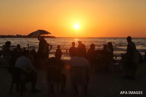 Palestinians enjoy their time at the beach of the Mediterranean sea on the coast of Gaza city on August 4, 2017. Photo by Ashraf Amra
