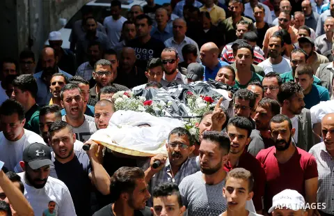 Palestinians carry the body of Palestinian Rafat Herbawi who had been killed in July 19 by Israeli soldiers after allegedly attempting car- ramming attack during his funeral in the West Bank of Hebron, on August 5, 2017....