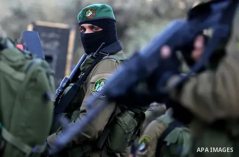 Members of the Ezzedine al-Qassam Brigades, the military wing of the Palestinian Islamist movement Hamas take part during the opening ceremony of Mazen Faqha square, in Nusseirat refugee camp, in the central Gaza Strip,...