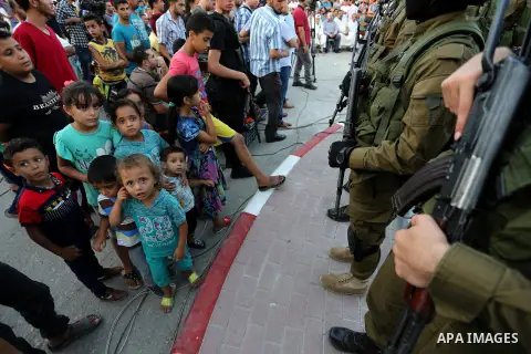 Members of the Ezzedine al-Qassam Brigades, the military wing of the Palestinian Islamist movement Hamas take part during the opening ceremony of Mazen Faqha square, in Nusseirat refugee camp, in the central Gaza Strip,...