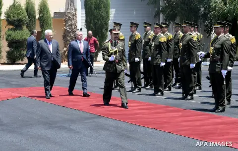 Jordan's King Abdullah II and Palestinian president Mahmud Abbas observes the honor guard during a visit in the West Bank city of Ramallah on August 7, 2017. Jordan's King began a rare visit to the occupied West Bank to...
