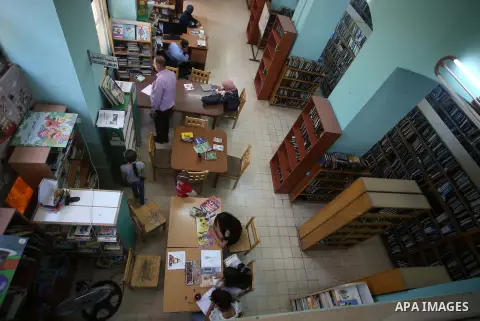 Palestinian students read books at Nablus public library in the West Bank city of Nablus, on August 6, 2017. Nablus public library, the largest, and the oldest, in all of Palestine, opened in 1960, and library includes a...
