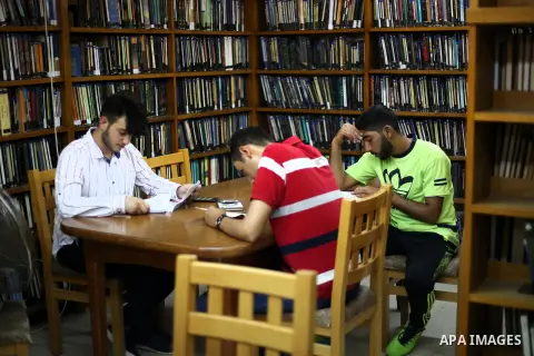 Palestinian students read books at Nablus public library in the West Bank city of Nablus, on August 6, 2017. Nablus public library, the largest, and the oldest, in all of Palestine, opened in 1960, and library includes a...