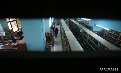 A Palestinian researcher selects a book at Nablus public library in the West Bank city of Nablus, on August 6, 2017. Nablus public library, the largest, and the oldest, in all of Palestine, opened in 1960, and library in...