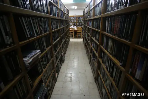 A Palestinian students reads a book at Nablus public library in the West Bak city of Nablus, on August 6, 2017. Nablus public library, the largest, and the oldest, in all of Palestine, opened in 1960, and library include...