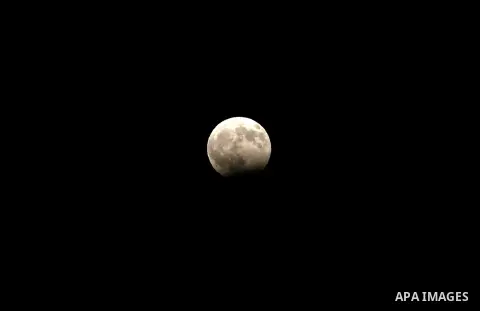 The moon goes into lunar eclipse as seen from the West Bank city of Hebron on August 07, 2018. The eclipse coincided with the moon being at it's closest point to earth on it's elliptical orbit. Photo by Wisam Hashlamoun