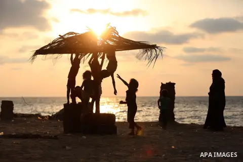 Palestinian children enjoy their time at the beach of the Mediterranean sea on the coast of Gaza city on August 9, 2017. Photo by Yasser Qudih