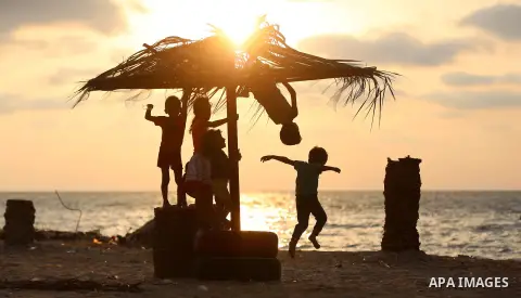 Palestinian children enjoy their time at the beach of the Mediterranean sea on the coast of Gaza city on August 9, 2017. Photo by Yasser Qudih