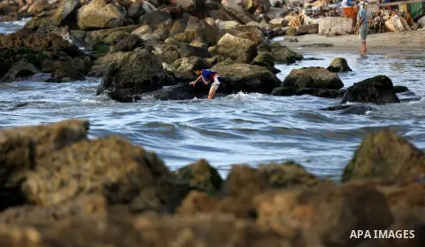 Palestinian children enjoy their time at the beach of the Mediterranean sea on the coast of Gaza city on August 9, 2017. Photo by Yasser Qudih