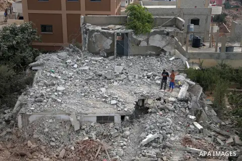 People walk through the rubble of the house of a Palestinian assailant after it was demolished by Israeli troops in the West Bank village of Deir Abu Mashal, near Ramallah August 10, 2017. Photo by Shadi Hatem