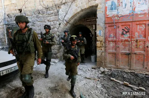 Israeli troops patrol a street in the West Bank city of Hebron, on August 10, 2017. Israeli authorities have demolished three homes and sealed off a fourth of Palestinians who carried out attacks that killed a soldier an...