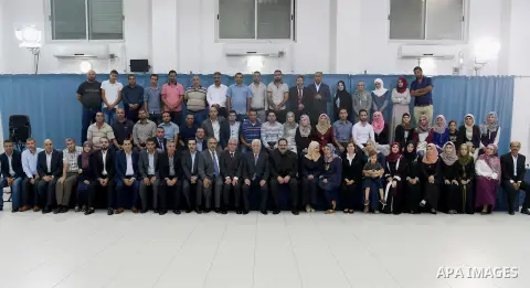 Palestinian President Mahmoud Abbas meets with Palestinian teachers who will be send to Kuwait, in the West Bank city of Ramallah, on August 12, 2017. Photo by Osama Falah