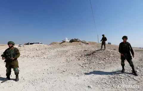 Israeli troops and bulldozers are seen as they demolish a house in the Palestinian bedouin village of Khashm al-Daraj in the southern area of Yatta, south of the West Bank city of Hebron, on August 14, 2017. Photo by Wis...