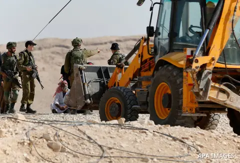 Israeli troops and bulldozers are seen as they demolish a house in the Palestinian bedouin village of Khashm al-Daraj in the southern area of Yatta, south of the West Bank city of Hebron, on August 14, 2017. Photo by Wis...