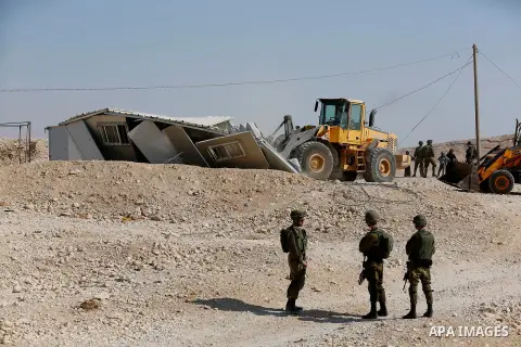 Israeli troops and bulldozers are seen as they demolish a house in the Palestinian bedouin village of Khashm al-Daraj in the southern area of Yatta, south of the West Bank city of Hebron, on August 14, 2017. Photo by Wis...