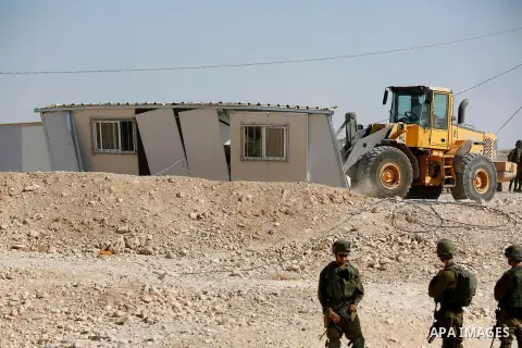 Israeli troops and bulldozers are seen as they demolish a house in the Palestinian bedouin village of Khashm al-Daraj in the southern area of Yatta, south of the West Bank city of Hebron, on August 14, 2017. Photo by Wis...