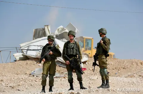 Israeli troops and bulldozers are seen as they demolish a house in the Palestinian bedouin village of Khashm al-Daraj in the southern area of Yatta, south of the West Bank city of Hebron, on August 14, 2017. Photo by Wis...