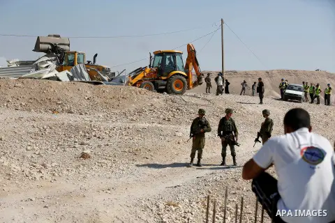 Israeli troops and bulldozers are seen as they demolish a house in the Palestinian bedouin village of Khashm al-Daraj in the southern area of Yatta, south of the West Bank city of Hebron, on August 14, 2017. Photo by Wis...