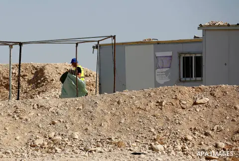 Workers empty EU donated houses in the Palestinian bedouin village of Khashm al-Daraj in the southern area of Yatta, south of the West Bank city of Hebron, on August 14, 2017. Photo by Wisam Hashlamoun