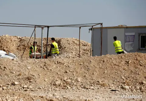 Workers empty EU donated houses in the Palestinian bedouin village of Khashm al-Daraj in the southern area of Yatta, south of the West Bank city of Hebron, on August 14, 2017. Photo by Wisam Hashlamoun