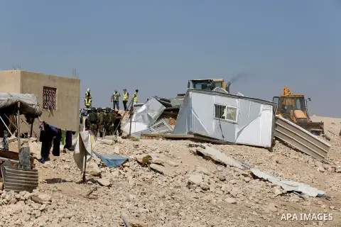 Workers empty EU donated houses in the Palestinian bedouin village of Khashm al-Daraj in the southern area of Yatta, south of the West Bank city of Hebron, on August 14, 2017. Photo by Wisam Hashlamoun
