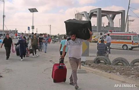 Palestinians wait for travel permits to cross into Egypt through the Rafah border crossing after it was opened by Egyptian authorities for humanitarian cases, in Rafah in the southern Gaza Strip on August 16, 2017. Photo...