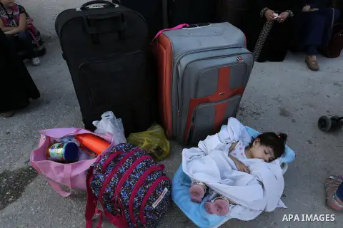 Palestinians wait for travel permits to cross into Egypt through the Rafah border crossing after it was opened by Egyptian authorities for humanitarian cases, in Rafah in the southern Gaza Strip on August 16, 2017. Photo...